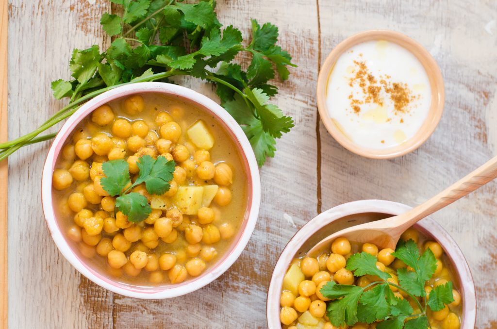 Two bowls of chickpea soup, with fresh coriander